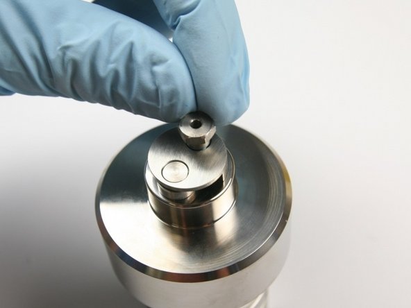 Unthread the retaining screw from the check valve body.