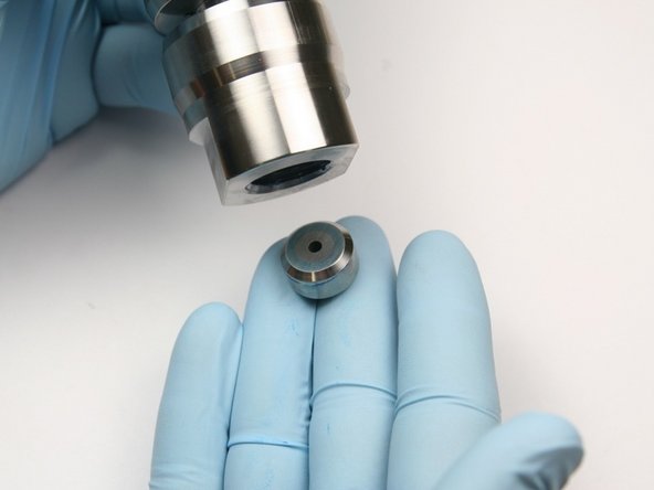 Unthread the high-pressure sealing head gland from the sealing head body.