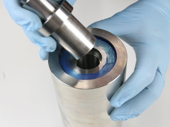 Put the nonstepped end of the push tool into the high-pressure cylinder.