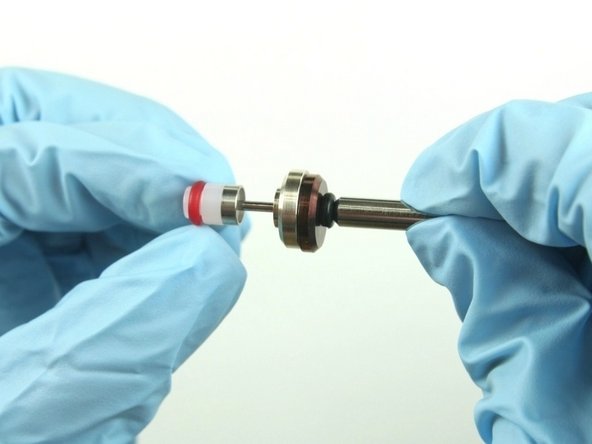 Slide the hoop and the high-pressure valve seal on to the valve stem with the hoop towards the brass back-up ring.