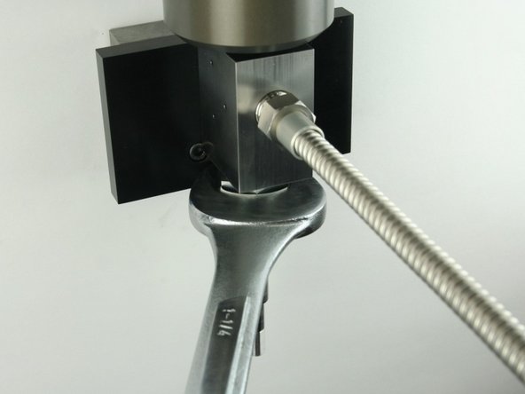 Tighten the high-pressure gland fitting using a 1-1/4&quot; wrench.