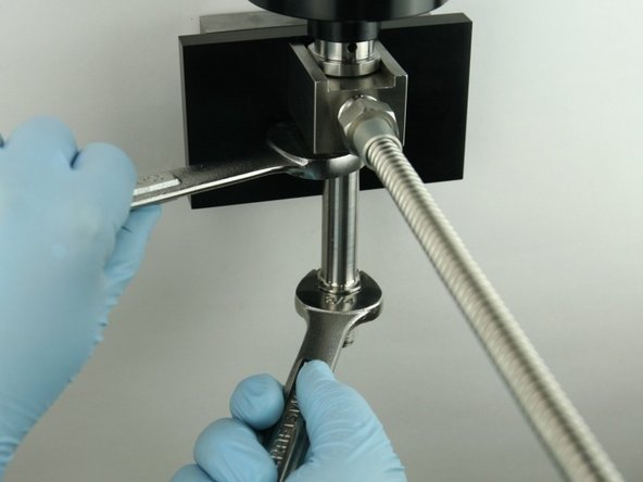 Tighten the nozzle tube to the valve using a 3/4&quot; and 7/8&quot; wrench.