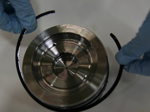 Put the first split ring onto the middle groove with the rounded side facing inward towards the T-seal.