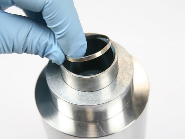 Place hoop in sleeve with sharp edge of hoop down towards HP cylinder