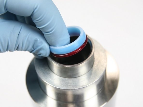 Insert assembled HP seal into sleeve with red o-ring down towards cylinder