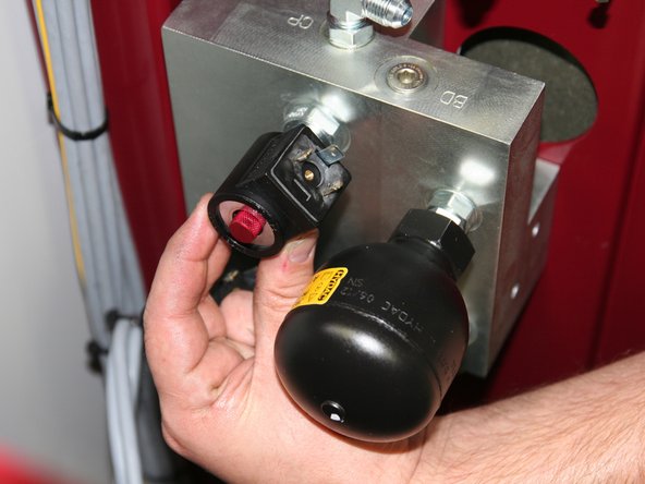 Install small 24VDC Coil (12586) onto small solenoid stem above large stem and beside bullet accumulator.