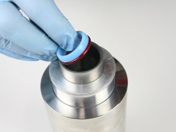 Put the high-pressure seal into the sleeve with the O-ring down.