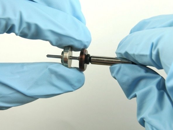 Slide the brass back-up ring on to the valve stem point with the chamfer side away from the stainless steel back-up ring.