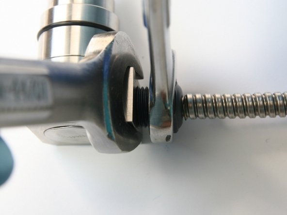 Tighten the high-pressure gland with 3/4&quot; and 5/8&quot; wrench.