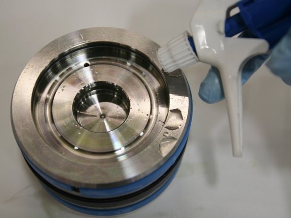 Apply hydraulic fluid to the entire piston with a spray bottle.