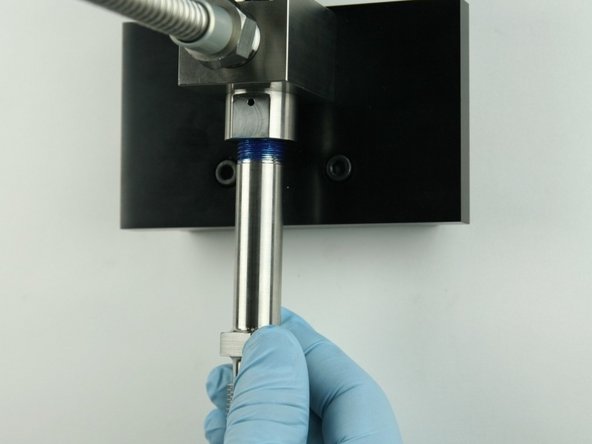 Thread the nozzle tube into the bottom of the valve body.