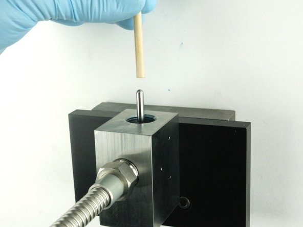 Push the valve stem with the dowel until it bottoms out.