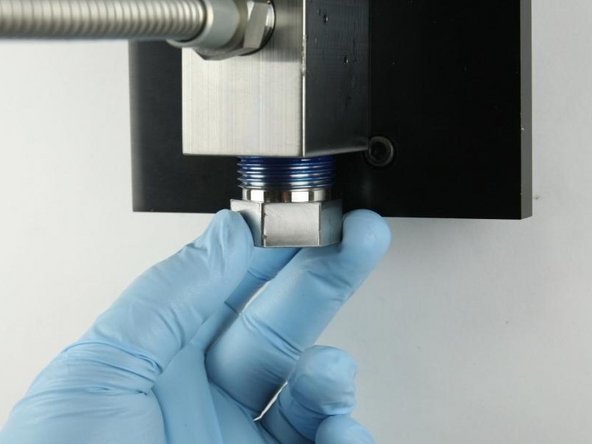 Unthread the high-pressure gland fitting from the valve body.