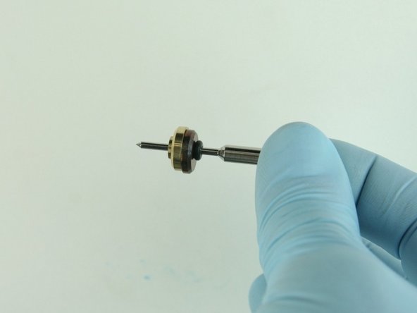 Slide the brass back-up ring on to the valve stem point with the chamfer side away from the stainless steel back-up ring.