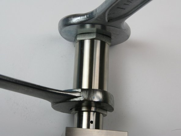 Loosen the adapter fitting from the actuator housing using a 1-1/4" and 1-1/16" wrench.