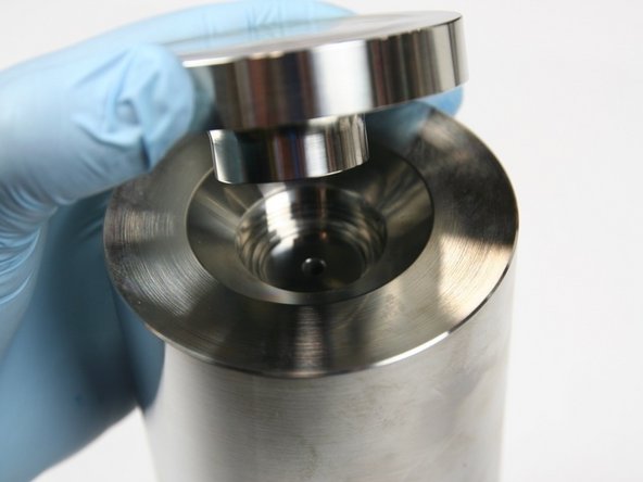 Place seal installation spacer tool on end of HP cylinder with step side down