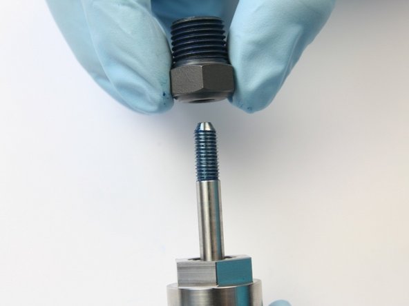 Slide the high-pressure gland with the collet onto the swivel shaft.