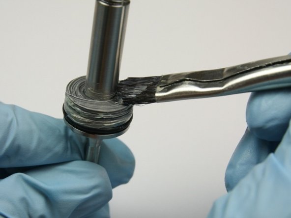 Apply a layer of lithium grease to the top of the second thrust washer.