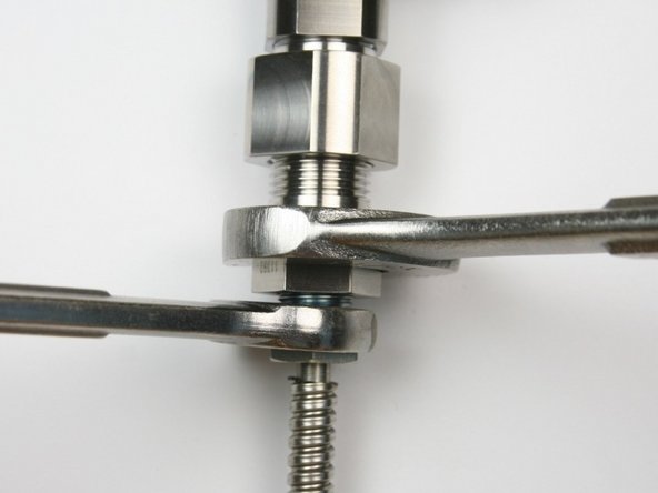 Tighten gland nut into bleed down valve adapter using 13/16" and 5/8" wrench