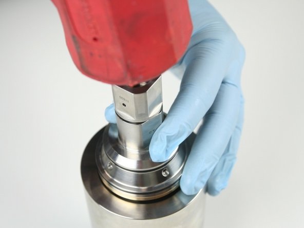 Use a rubber mallet to tap the check valve into the high-pressure cylinder.
