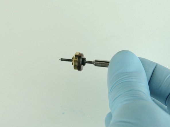 Slide the brass back-up ring on to the valve stem point with the chamfer side away from the stainless steel back-up ring.