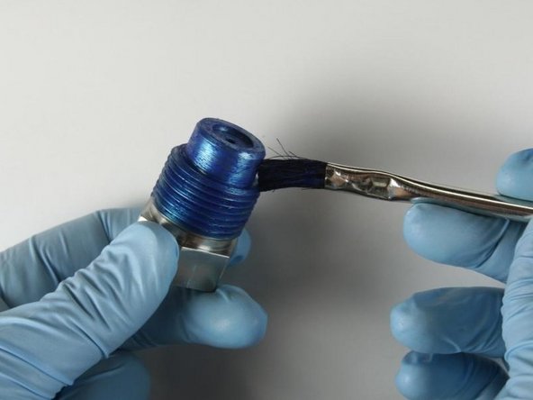 Reapply Blue Goop to the threads of the high-pressure gland fitting.