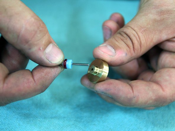 Slide Needle Guide onto the back end of the Needle. Make sure larger diameter end of Needle Guide faces towards HP Seal.