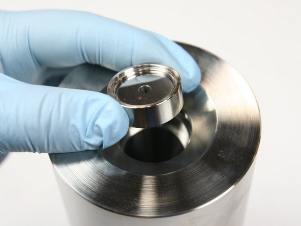 Insert LP poppet and LP poppet basket into spacer tube in HP cylinder