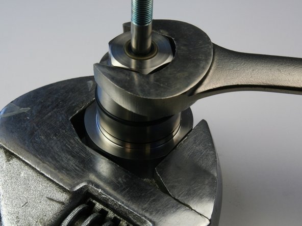 Loosen the bearing half from the seal half of the swivel housing with an adjustable wrench and a 1-1/8" wrench.