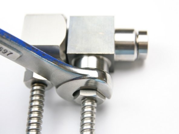 Tighten the high-pressure gland nut into the swivel housing with a 5/8&quot; wrench.