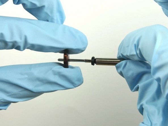 Slide the stainless steel back-up ring on to the valve stem point with the chamfer side towards the O-ring.