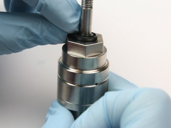 Put the wiper over the swivel shaft and down into the top of the bearing half of the swivel housing.