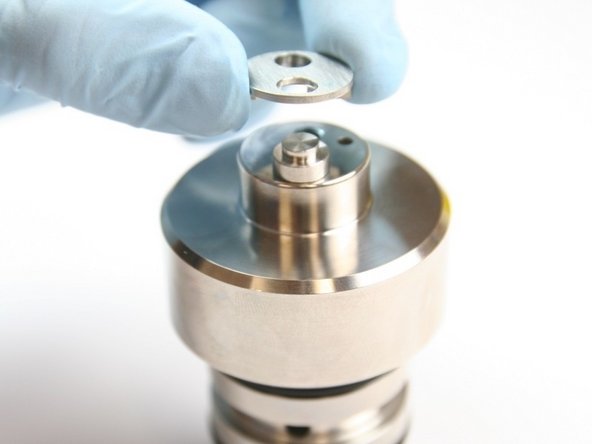 Remove the inlet poppet housing from the top of the check valve body.