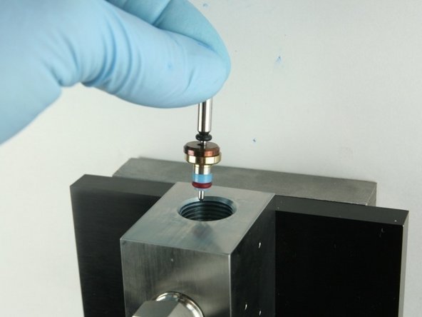 Put the point of the valve stem into the valve body.