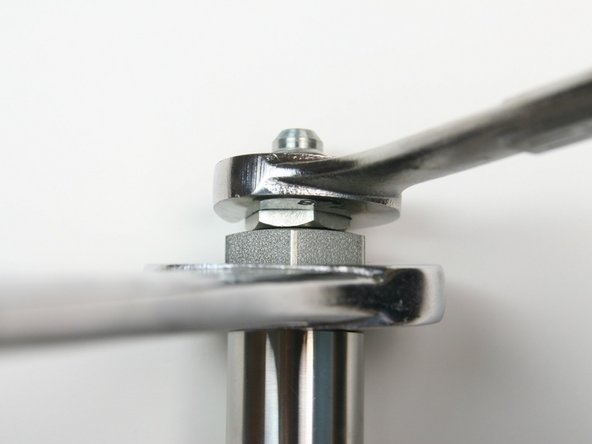 Loosen the hydraulic fitting from the adapter fitting using a 1-1/4" and 7/8" wrench.