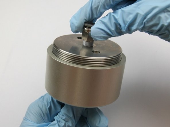 Put the actuator housing in the soft-jaw vise if necessary.