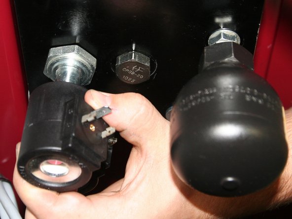 Remove both 24VDC coils from solenoids on back of old control manifold.