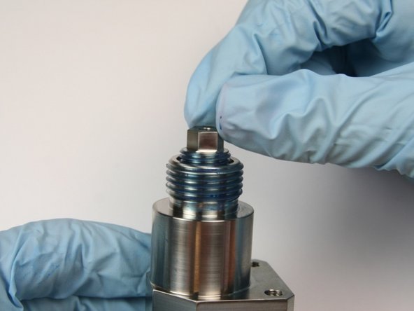 Thread in back-up screw into top of bleed down valve body