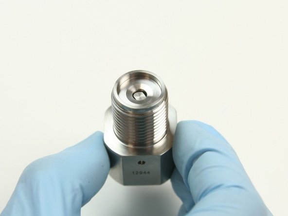 Place the flow reducer into the hole beneath the seat cavity in the outlet adapter.