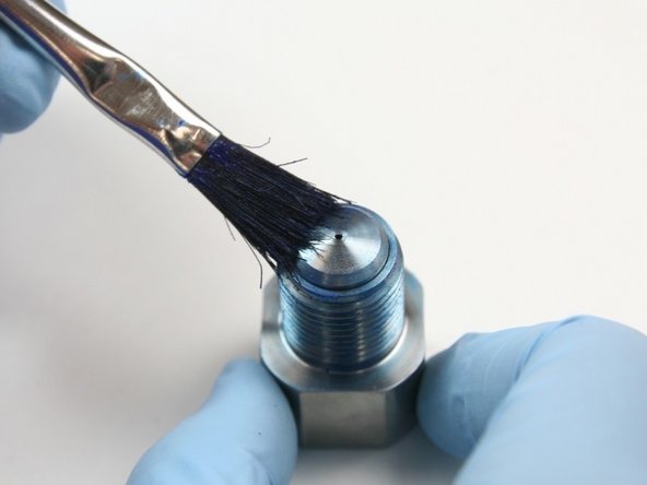 Apply a layer of Blue Goop to the top of the poppet seat that is sitting in the outlet adapter.