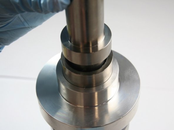 Use the blunt (non-stepped) end of the installation tool to hand press the high-pressure seal into the high-pressure cylinder.