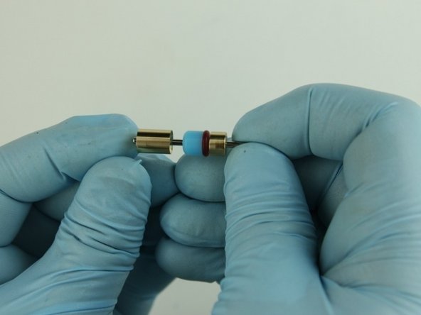 Put the back-up ring with the concave side towards the seal then slide on the poppet needle behind the high-pressure seal.