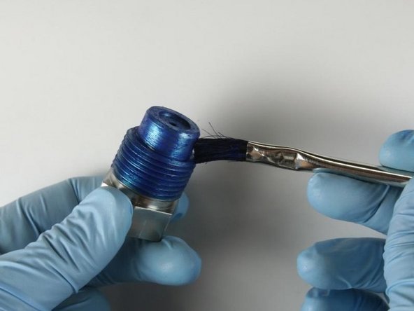 Reapply Blue Goop to the threads and to the top of the high-pressure gland fitting.