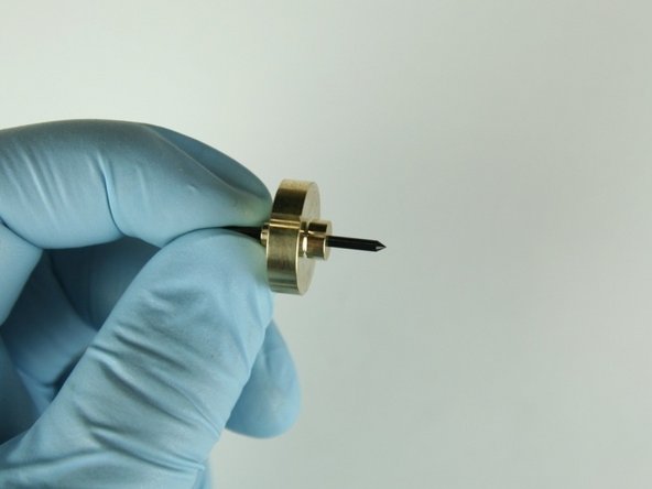 Slide the needle bearing  onto the needle point with the smaller step away from the needle point.