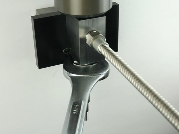 Tighten the high-pressure gland fitting using a 1-1/4" wrench.