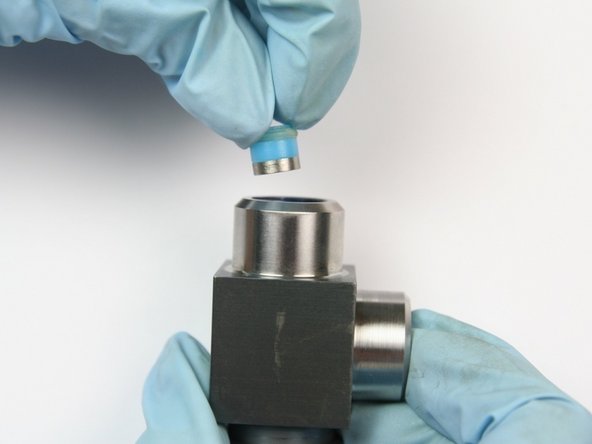 Put the high-presssure seal assembly into the swivel housing, with the hoop first, behind the back-up ring.