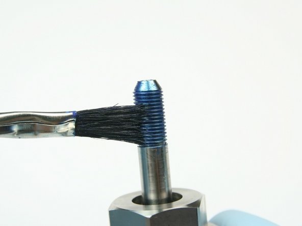 Apply Blue Goop to the threads of the swivel shaft.