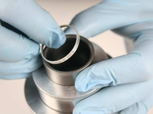 Hold the sleeve down against the cylinder with one hand to be sure it doesn't raise up while installing the seal.