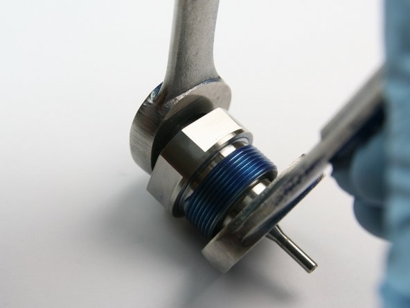 Loosen the swivel nut from the swivel shaft with a 3/4&quot; and 11/16&quot; wrench.