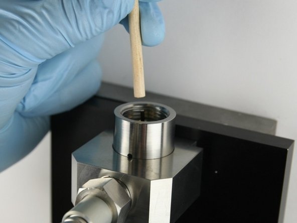 Use the dowel to push the needle into the valve body until the needle bearing bottoms out.